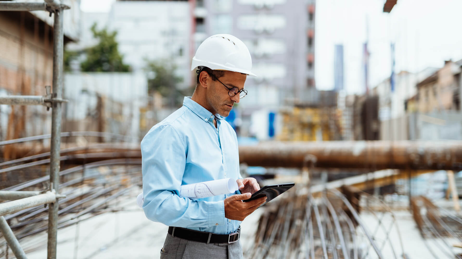 A male construction manager on-site overseeing a project looking to maintain employee retention.