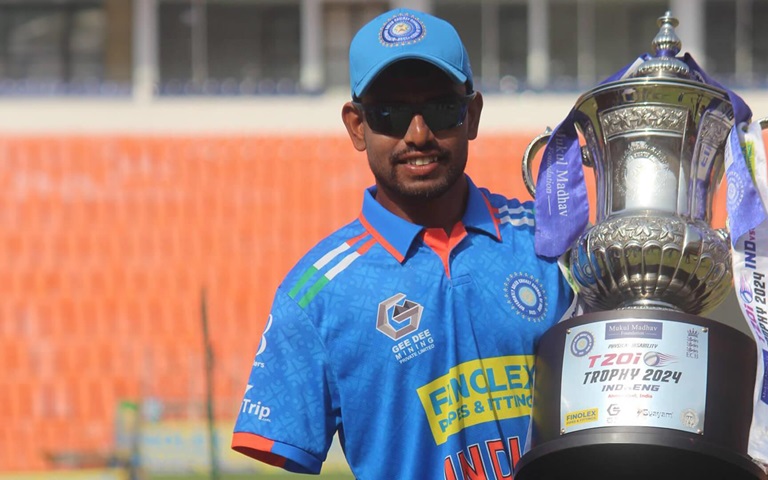 Shivashankara GS, Actalent Employee, holding large metal trophy