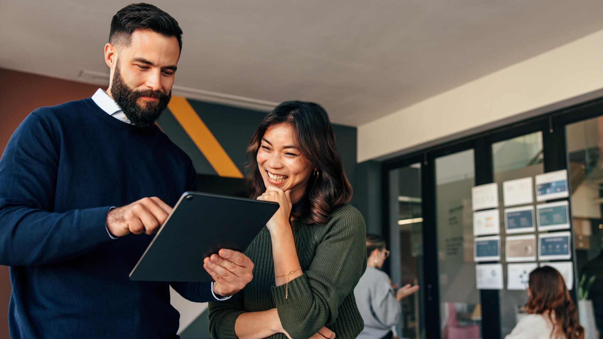 man and woman reading Actalent's September 2024 labor market and economy report on a tablet